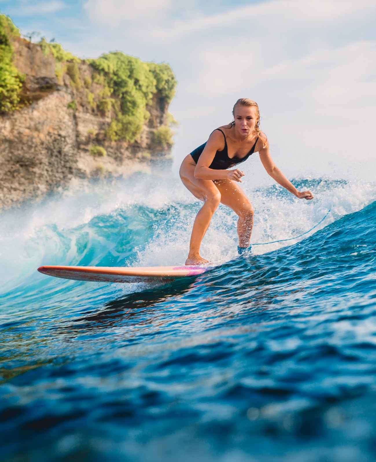 a girl is surfing in Weligama beach sri lanka